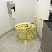 Men who stole $6M golden toilet from English mansion sentenced to prison terms